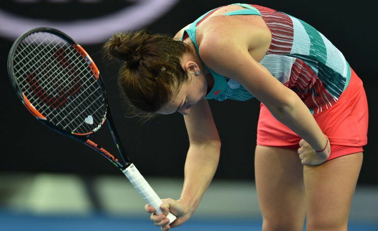 Romania's Simona Halep reacts during her women's singles match against China's Zhang Shuai on day two of the 2016 Australian Open tennis tournament in Melbourne on January 19, 2016. AFP PHOTO / SAEED KHAN-- IMAGE RESTRICTED TO EDITORIAL USE - STRICTLY NO COMMERCIAL USE / AFP / SAEED KHAN